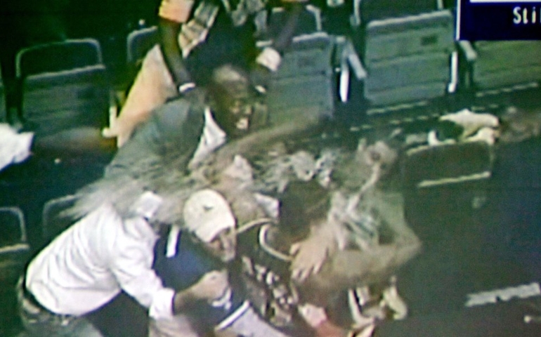 In this video framegrab shown during a news conference, in Pontiac, Mich, on Dec. 8, 2004, by Oakland County (Mich). prosecutors, spectator John Green, center with baseball cap , holds Indiana Pacers' Ron Artest during a fight between fans and several Indiana players, at the Palace in Auburn Hills, Mich., Nov. 19, 2004. Cash was lost, reputations were tainted and the NBA was shaken on Nov. 19, 2004, when the Indiana Pacers, Detroit Pistons and fans were involved in one of the worst brawls in U.S. sports history. Players from both teams would rather not rehash the ugly series of events and the aftermath, but that won't stop many from wondering what lessons were learned.