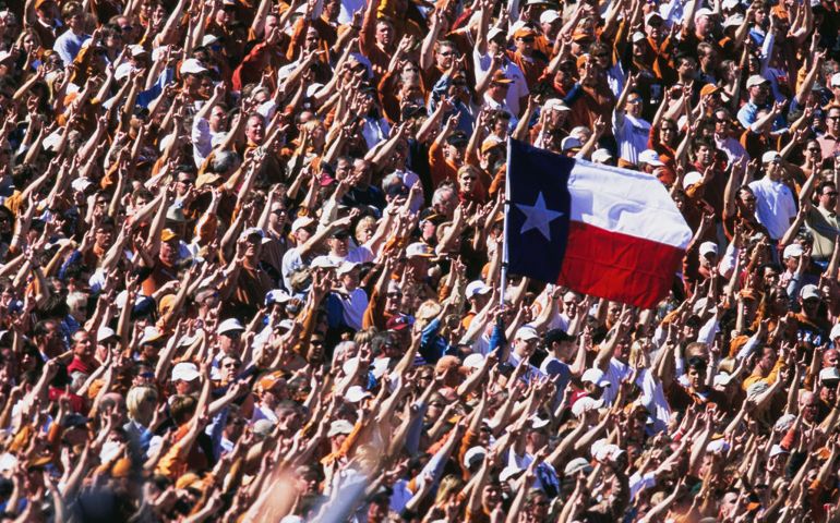 Fans for the University of Texas Longhorns raise the Texas State flag during the NCAA Southwest Conference college football game against the University of Oklahoma Sooners on 6th October 2001 at the Cotton Bowl Stadium in Dallas, Texas, United States. The Oklahoma Sooners won 14 - 3.