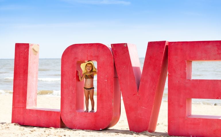 A little girl playing at the beach.