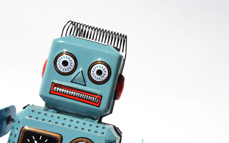 Portrait of a vintage tin toy robot isolated on white background.
