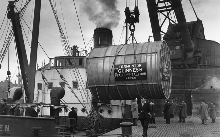 14th March 1949: A 10 ton stainless steel fermenting tun, constructed in Leven, Glasgow, being hoisted by a crane at Glasgow docks onto the ship, 'Lairdsglen', en route to the Guinness Brewery at Dublin. The tun can hold 150 000 pints of Guinness.