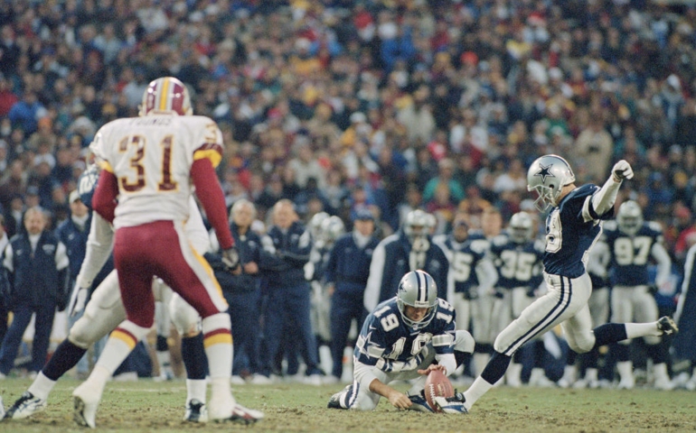 John Jett #19 places the ball as Chris Boniol #18, Kicker for the Dallas Cowboys kicks foe goal during the National Football Conference East game against the Washington Redskins on 22 December 1996 at Robert F. Kennedy Memorial Stadium , United States. The Redskins won the game 37 - 7.