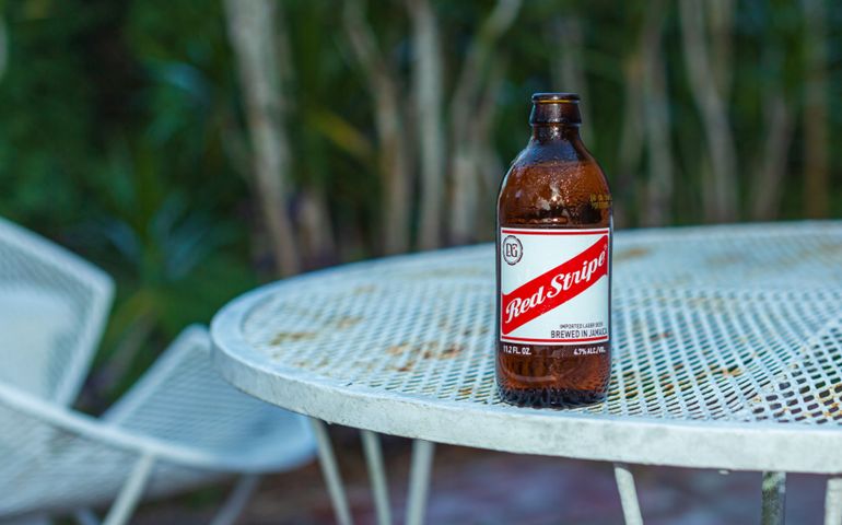 An opened cold "Red Stripe" beer ready to drink after a hot afternoon