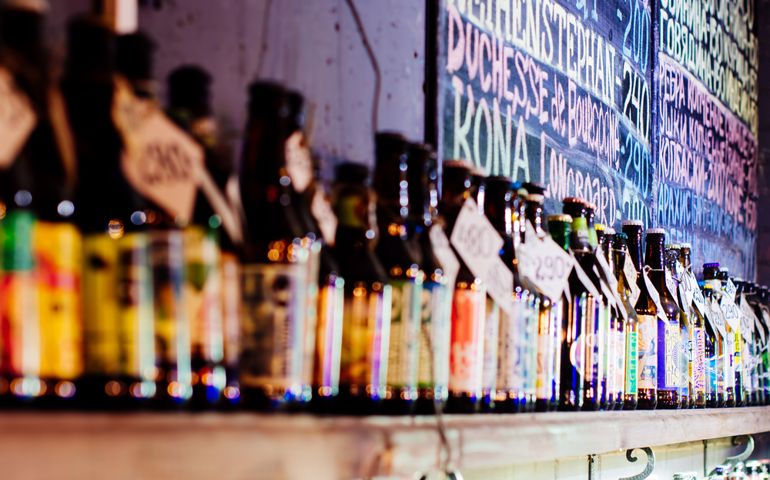 Various types of bottled beer are displayed on shelf in a bar in St-Petersburg, Russia