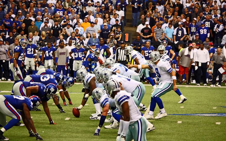 Dallas Cowboys Quarterback Tony Romo points to a New York Giants defender as he calls signals