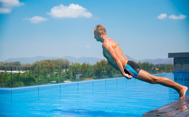 Unemotional funny man falling into swimming pool. Summer vacation