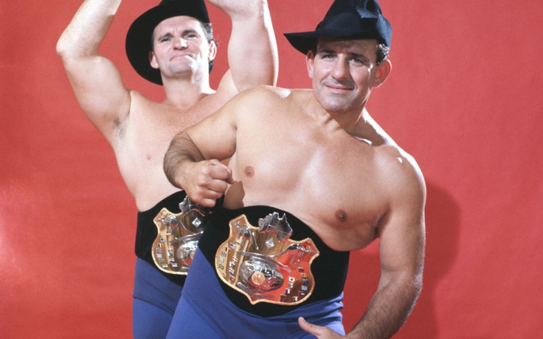 NEW YORK, NY - OCTOBER, 1963: Professional wrestlers Australian Roy Heffernan (1925-1992) and tag team partner Italian Australian Al Costello (1919-2000) of the Fabulous Kangaroos pose for a portrait with the WWE International World Championship belts circa October, 1963 in New York, New York.