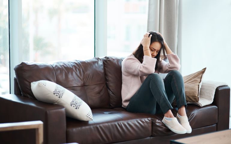 Shot of a young woman experiencing mental anguish at home