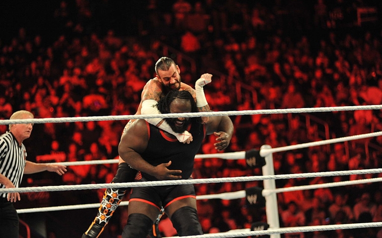 ATLANTA, GA - OCTOBER 31: CM Punk and Mark Henry battle during their WWE match at the WWE Monday Night Raw Supershow Halloween event at the Philips Arena on October 31, 2011 in Atlanta, Georgia.