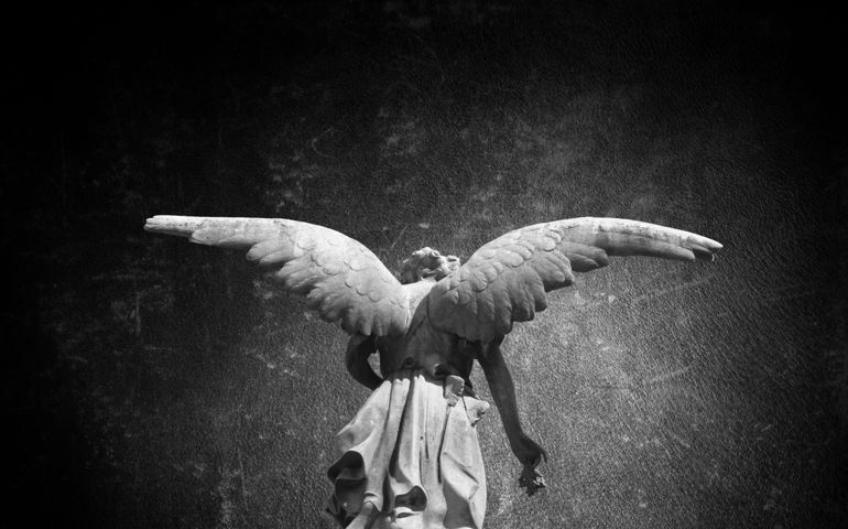 Angel sculpture in public cemetery of ¨Recoleta¨.(Buenos Aires, Argentina), with a grunge texture background.