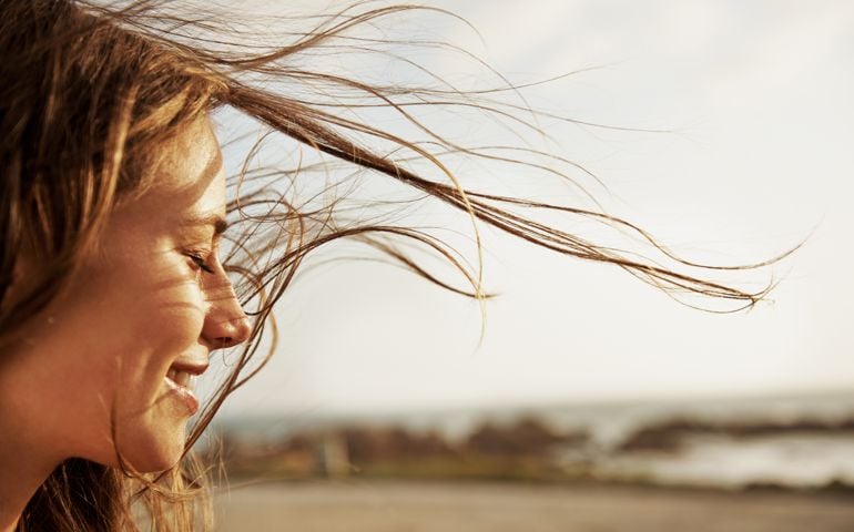 Cropped view of a young woman with the wind in her hair