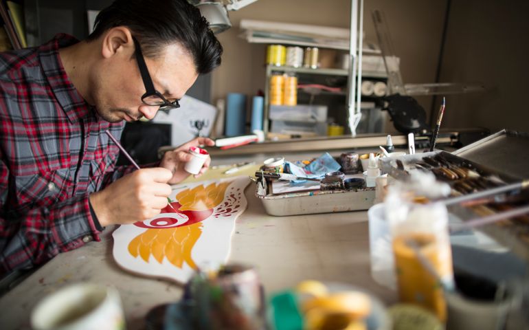 An artist working with a paint brush