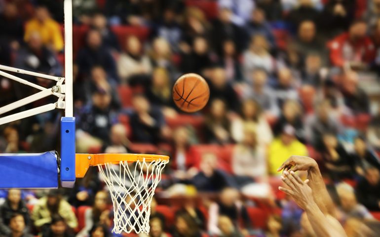Scoring the winning points at a basketball game , motion blur