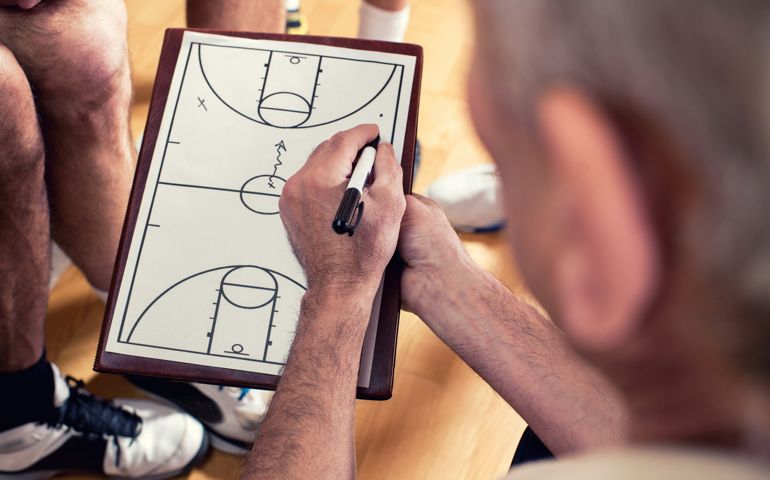 Close-up of basketball coach drawing a strategy for his players..