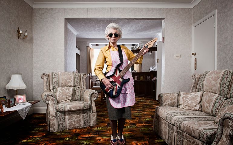 Senior woman playing electric guitar