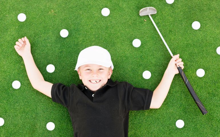 Young Boy Having Fun On Golf Course