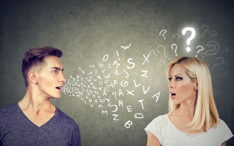 Language barrier concept. Handsome man talking to an attractive young woman with question mark