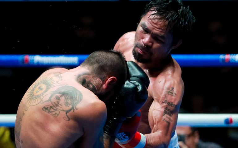 Philippines' Manny Pacquiao (R) fights Argentina's Lucas Matthysse during their world welterweight boxing championship at Axiata Arena in Kuala Lumpur.