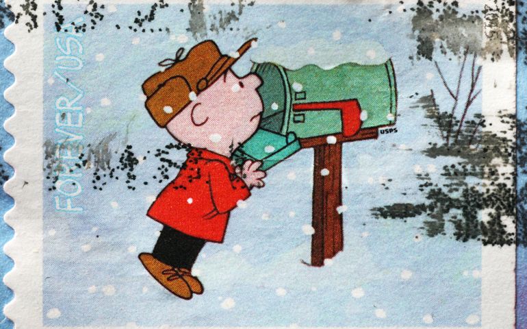Charlie Brown checking the mailbox on postage stamp