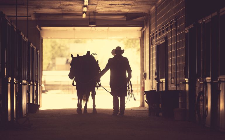 Cowboy at a horse stable