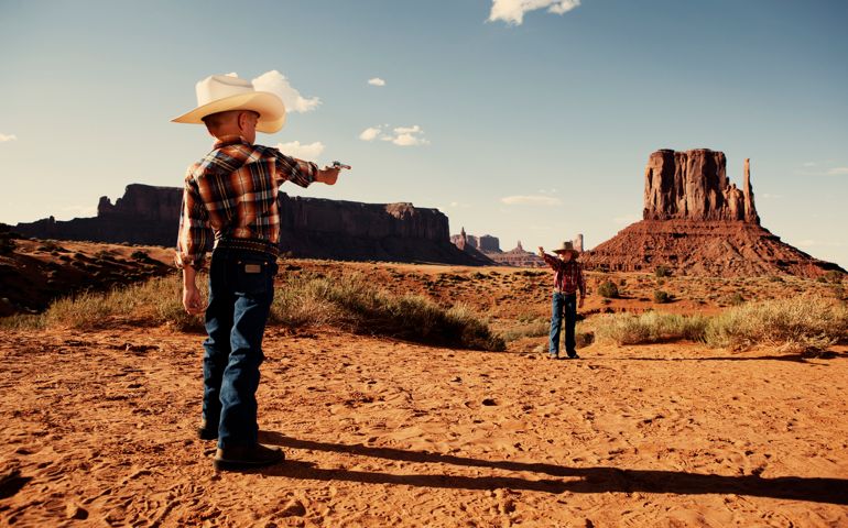Don't mess with the law. This young sheriff is ready to tame the Wild West. Taken in historical Monument Valley.