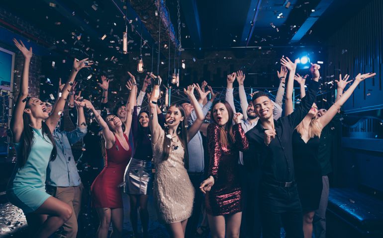 Portrait of good-looking festive lady guy having fun raise hands arms shout laugh, emotional have vent holidays free time rejoice suit dress discotheque