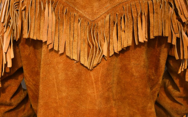An image of an old vintage style leather coat with long fringes.