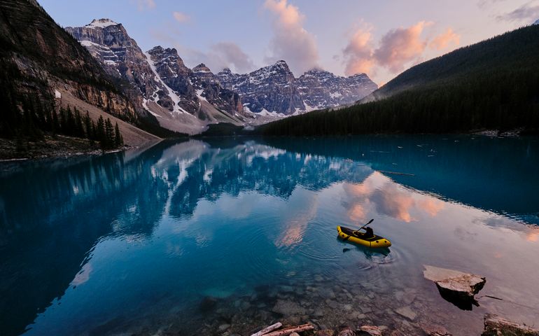 Mountain range reflects in the blue water