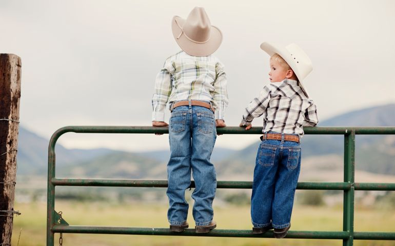 A couple of young cowboys survey the ranch.