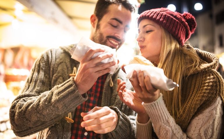 couple eating at the christmas market