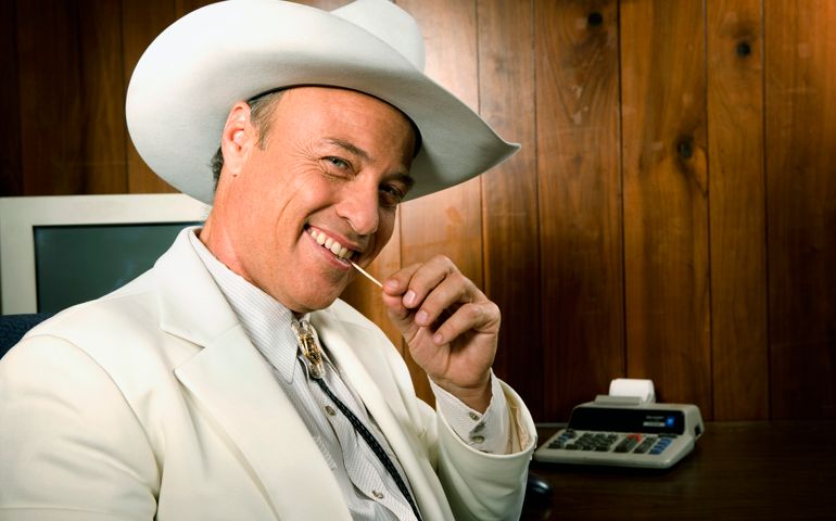 Smiling cowboy businessman with toothpick