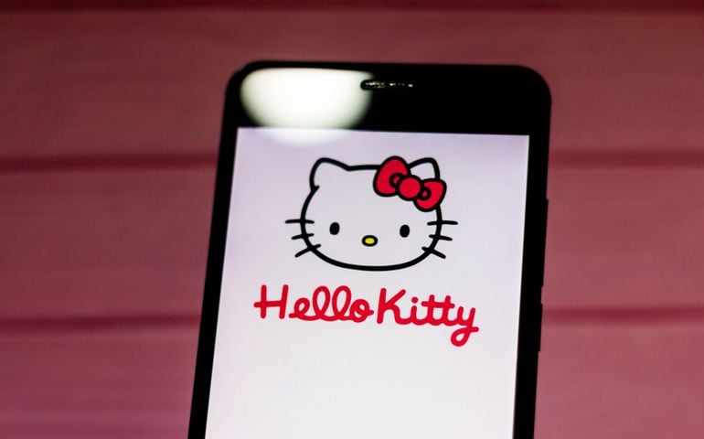 Hello Kitty logo, a character created by the Japanese company Sanrio, displayed on the screen of the mobile device