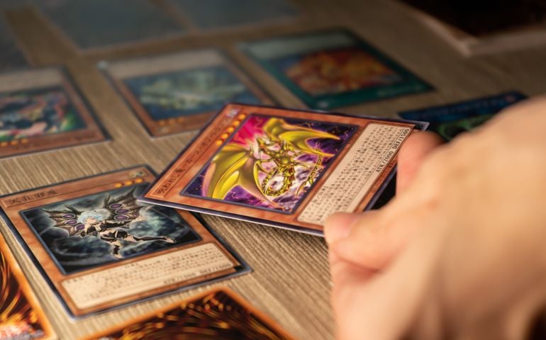 A man playing Yu-Gi-Oh trading card game.