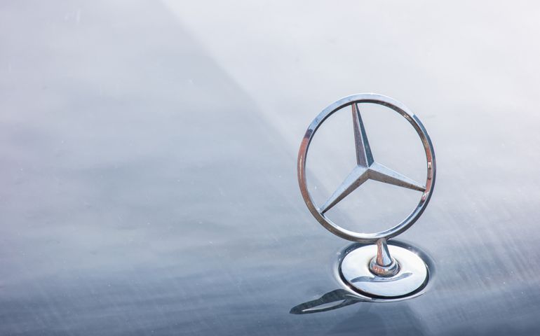 Mercedes Benz logo close up on a car grill. Mercedes-Benz is a German automobile manufacturer. The brand is used for luxury automobiles, buses, coaches and trucks.