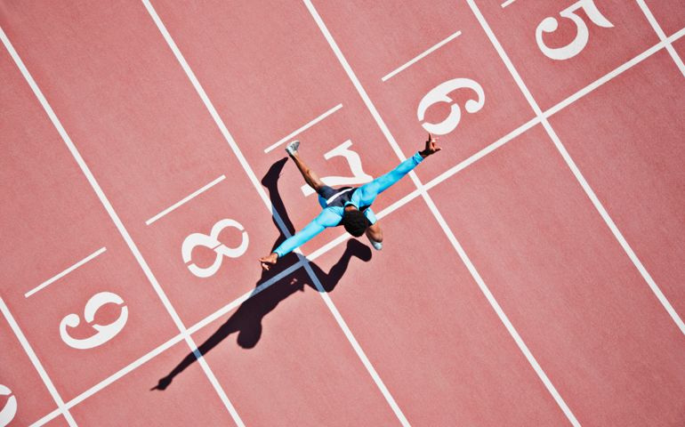 Runner crossing finishing line on track