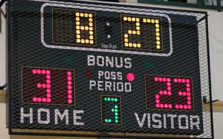 School basketball scoreboard during a game.