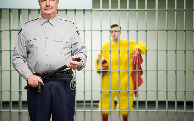 Guard and prisoner in chicken suit