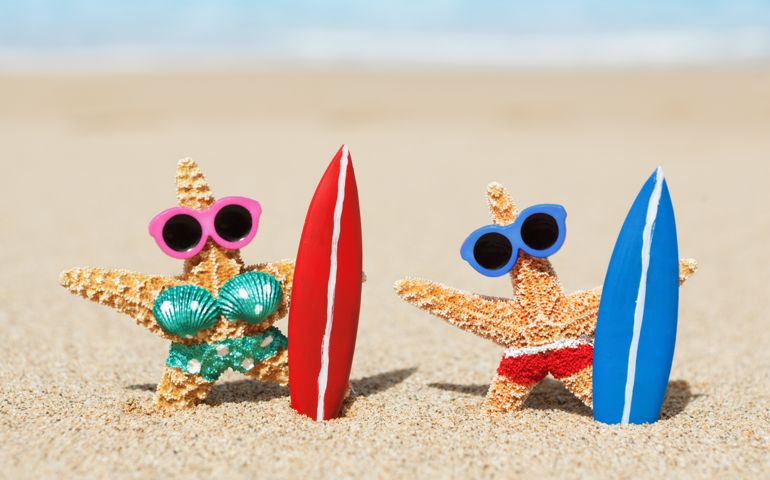 A starfish couple having a summer beach vacation on the tropical paradise beach of Hawaii.Location: Kauai, Hawaii, USA.