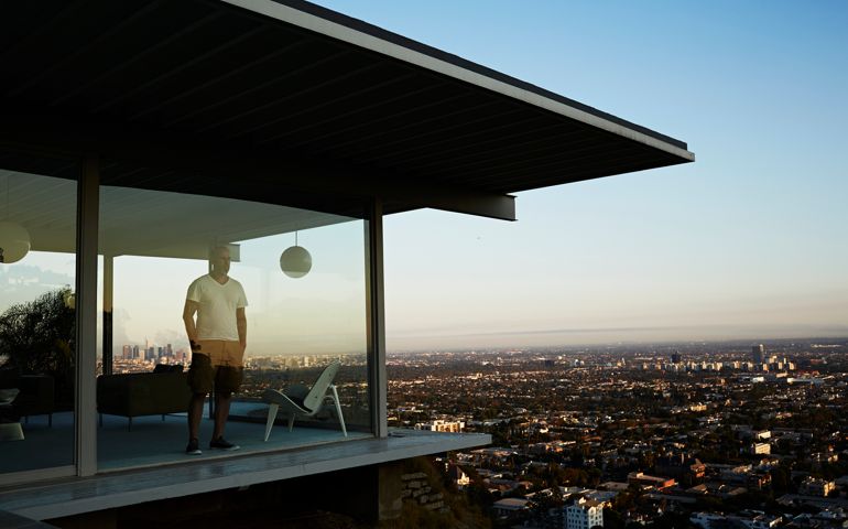Man Standing In House Overlooking Los Angeles.