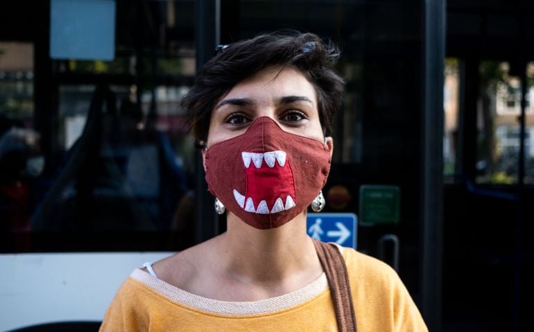 woman wearing a funny red mask with a shark jaw during the covid 19 crisis.