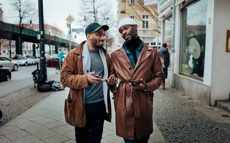 A couple walking down the street after meeting each other on a dating app, on their way to eat some food.