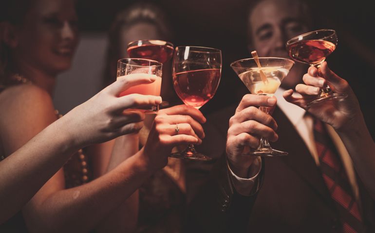 A man and four women are celebrating their success.
