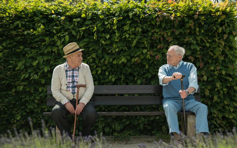 Germany, Worms, Two old friends sitting on bench in park