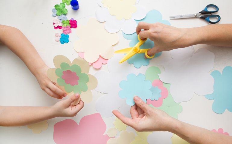 mother and the child prepare together Paper decor. children's creativity. Tools and materials for children's art creativity on table. Mother's day or March 8 greeting card DIY idea