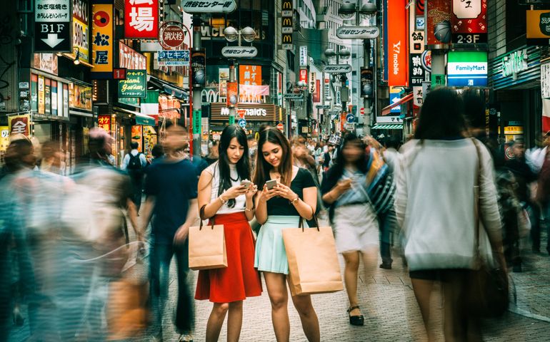 Japanese girlfriends hanging out on Shibuya streets of Tokyo. Japan.