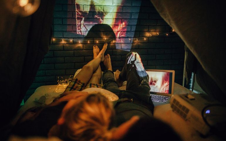 Romantic couple watching movies in home theater