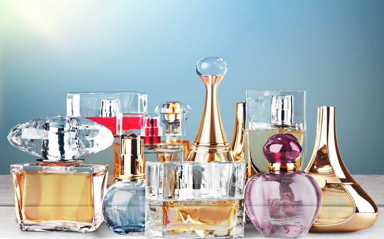 Aromatic Perfume bottles on wooden table on