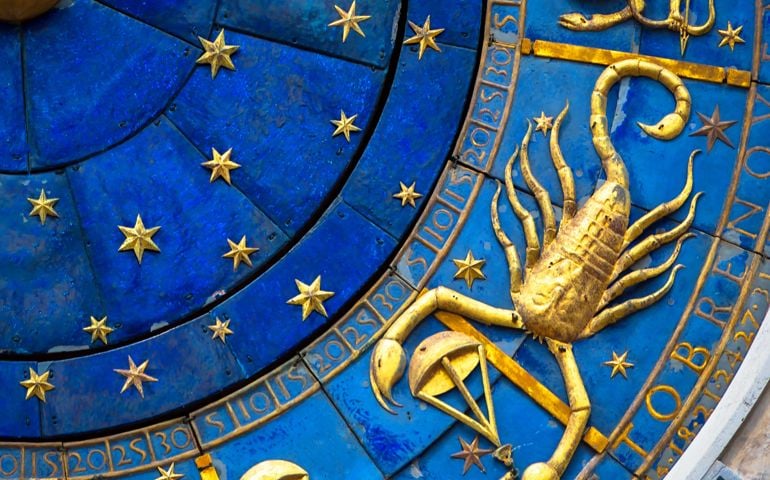 Scorpio astrological sign on ancient clock, medieval Torre dell’Orologio in Venice. Detail of Zodiac wheel with scorpion. Golden horoscope icon of scorpio closeup. Symbol of scorpion on star circle. Astrology concept.