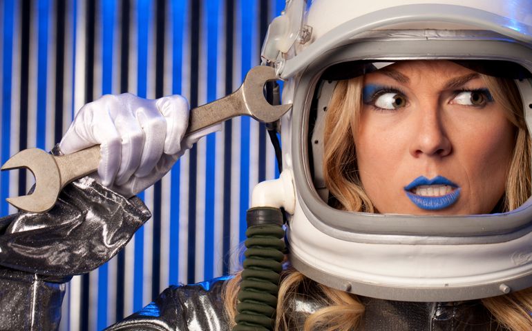Female Astronaut Holding Wrench