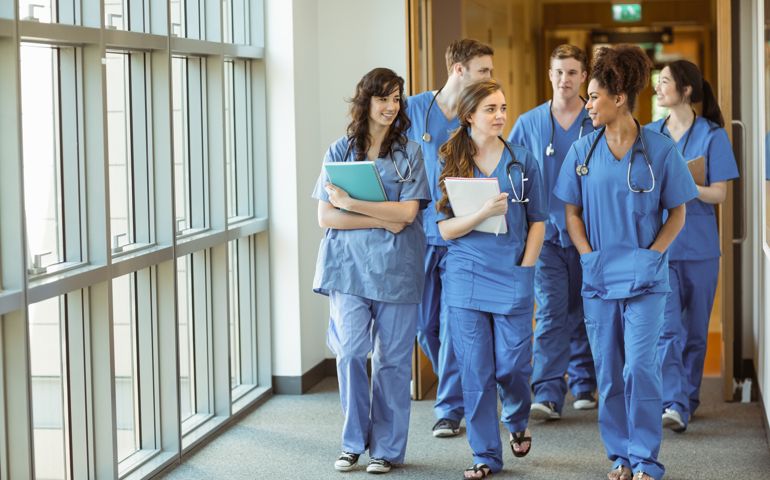 Medical students walking through corridor at the university